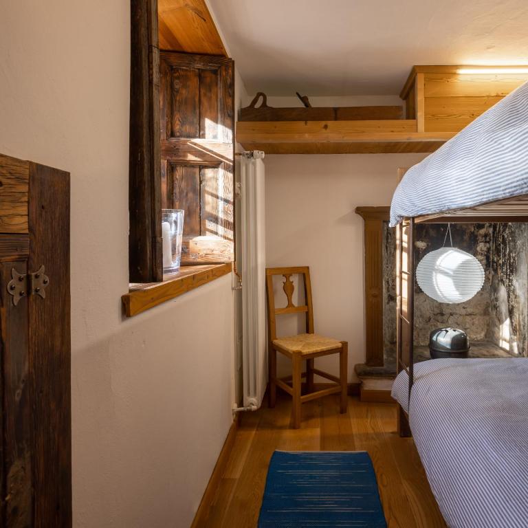 Postel nebo postele na pokoji v ubytování Rifugio Uschione