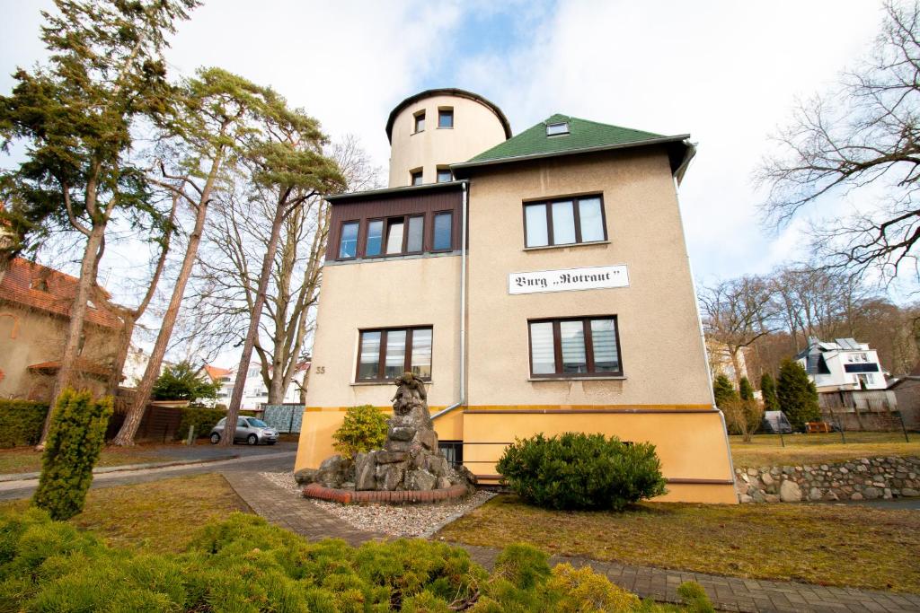 a building with a statue in front of it at Burg Rotraut #4 in Ostseebad Sellin