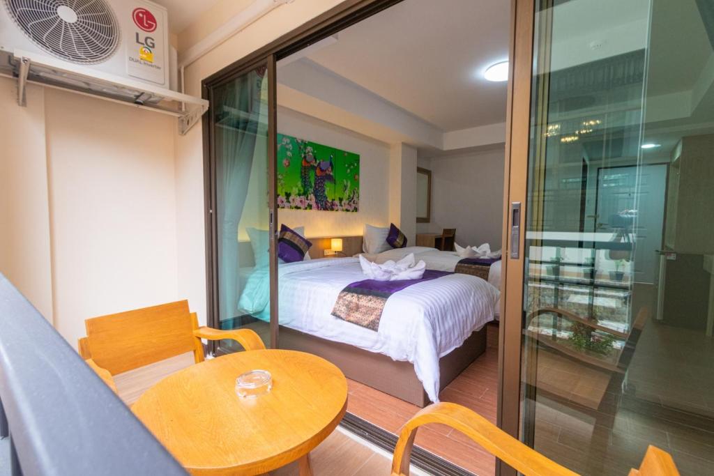 Postel nebo postele na pokoji v ubytování Peacock De Pai Hotel