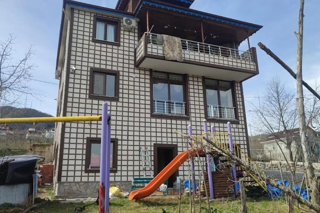 a house with a playground in front of it at Trabzon Deniz Manzaralı villa in Araklı