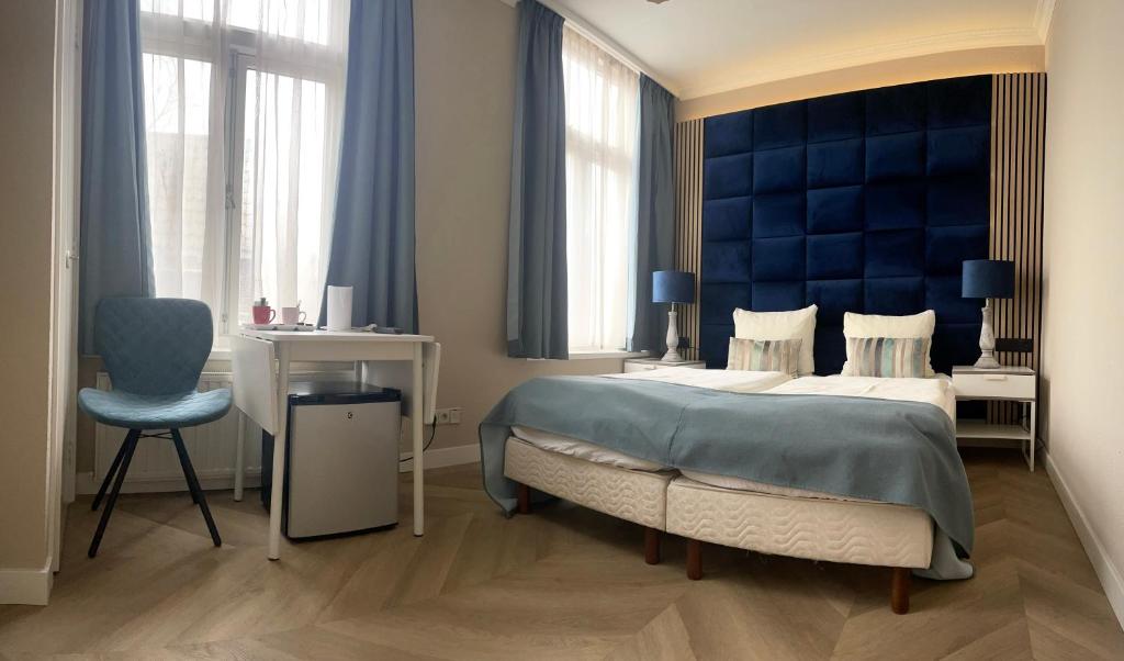 Postel nebo postele na pokoji v ubytování Hotel van Oppen
