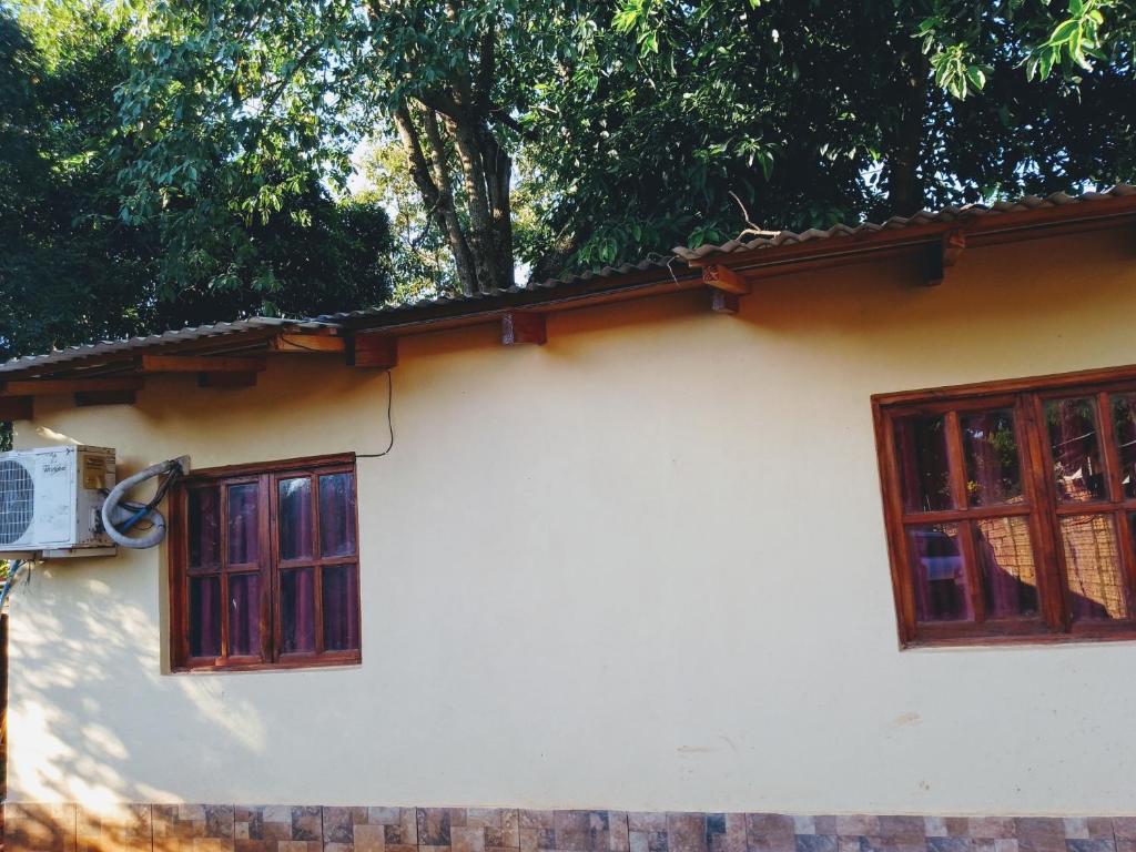 a house with two windows and a fence at Familia Goncalvez in Puerto Iguazú