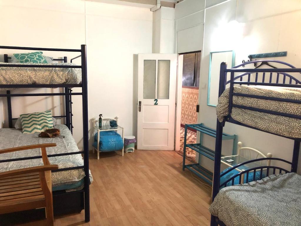 a room with four bunk beds and a hallway at Buddha Bee - 18 to 35 years only in Lagos