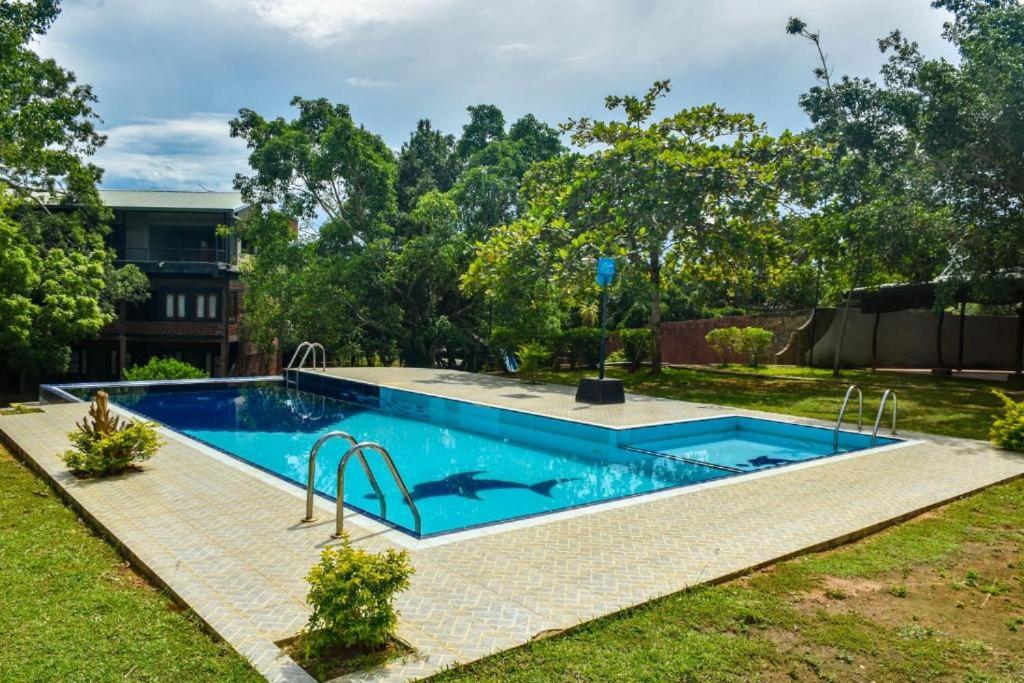 a swimming pool in the yard of a house at Vintara Eco Resort in Hambantota