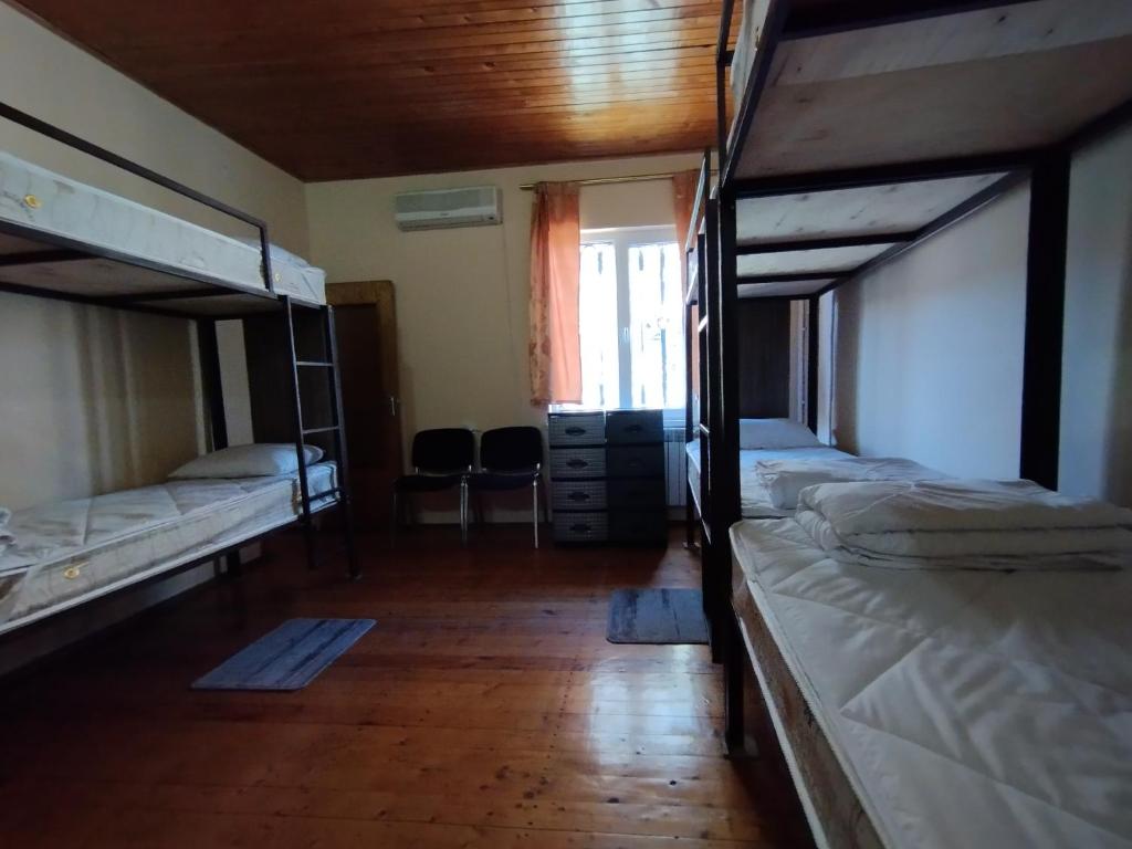 a room with two bunk beds and a wooden floor at Wooden_Room_Hostel in Yerevan