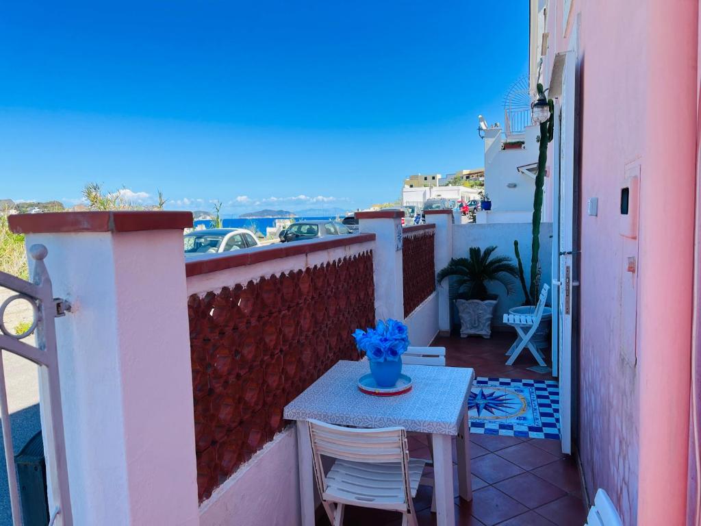 a small table and chairs on a balcony at Lunatica Immobilevante in Ponza