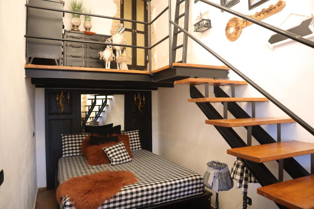 Habitación con cama elevada y escalera. en CASASTASIA HOME, en Torre del Greco