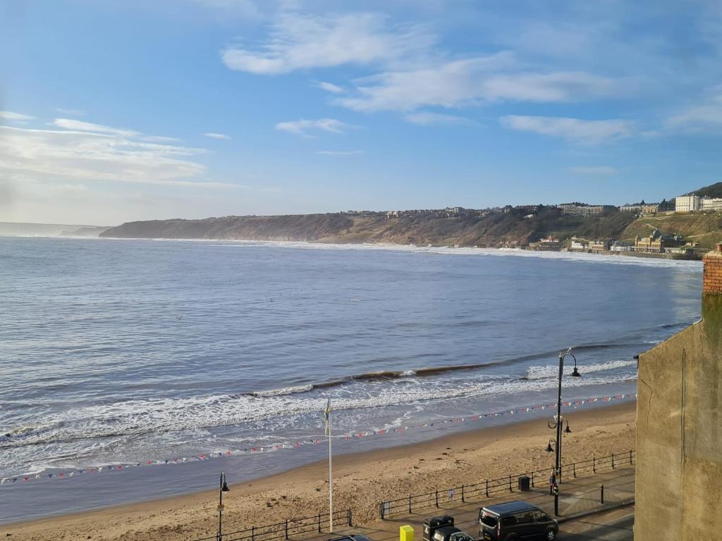 a view of a beach with a car parked on it at Yorkshire Rose in Scarborough