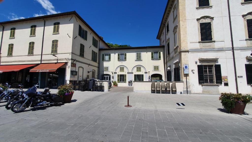 a group of motorcycles parked in a street next to buildings at Ostello Antica Filanda in Santa Sofia