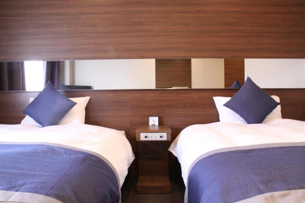 Postel nebo postele na pokoji v ubytování Hotel Il Credo Gifu