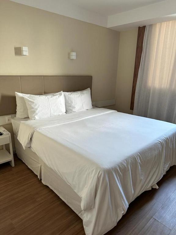 Postel nebo postele na pokoji v ubytování Linhares Design Hotel