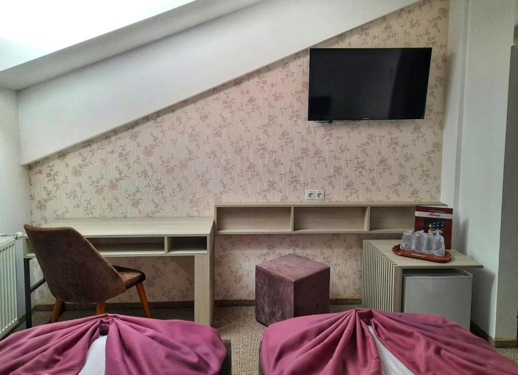 Postel nebo postele na pokoji v ubytování Hotel Alexis