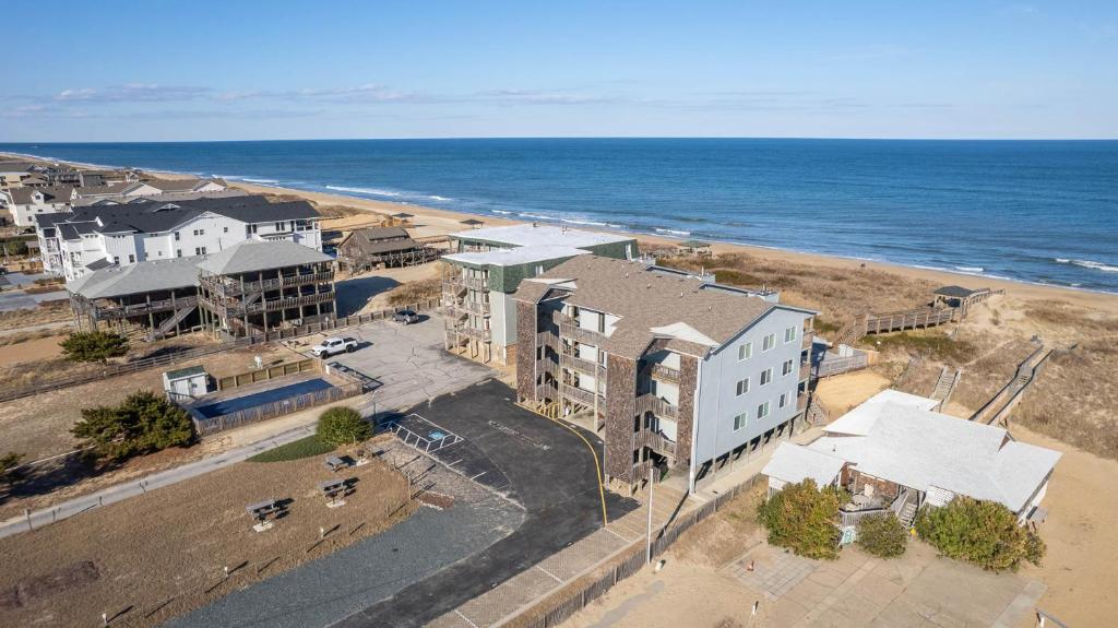 an aerial view of a beach with buildings and the ocean at High Dunes in Kill Devil Hills