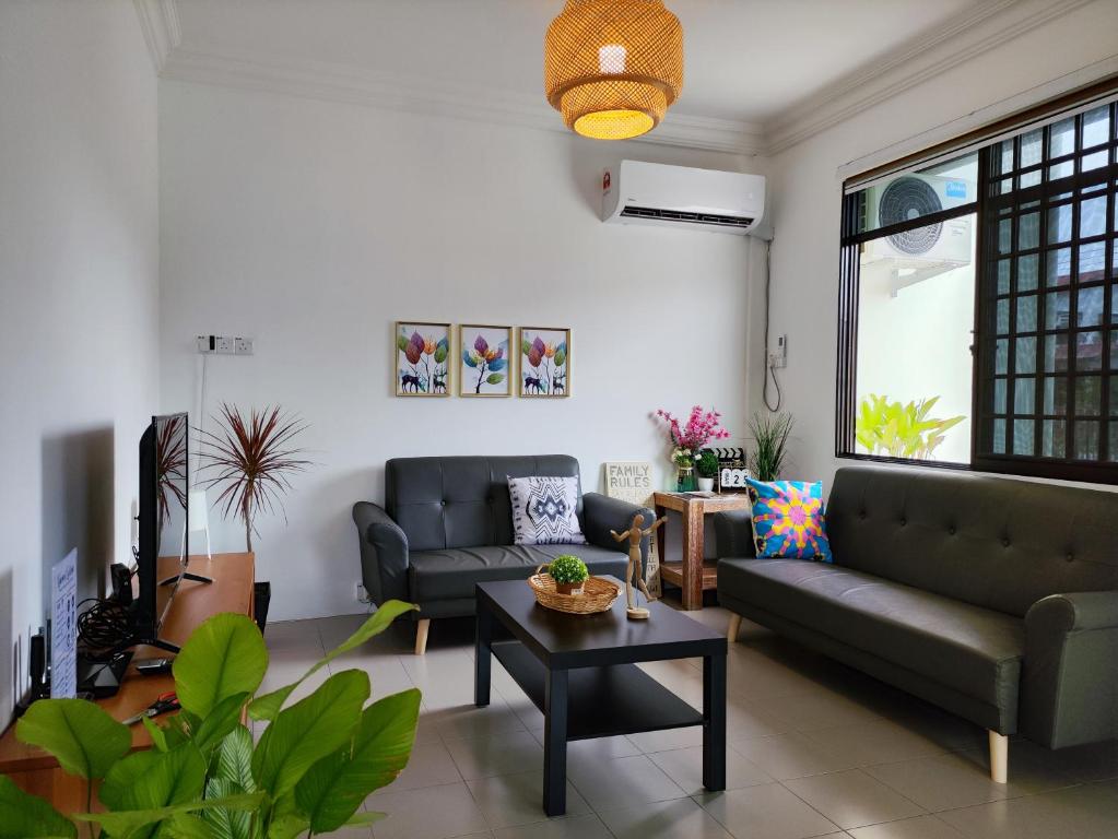 a living room with two couches and a table at Grand Height Homestay 3A 10pax 4Rooms in Sibu
