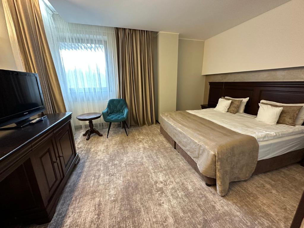 Un pat sau paturi într-o cameră la Hotel Alpin Aparthotel Apartament 301