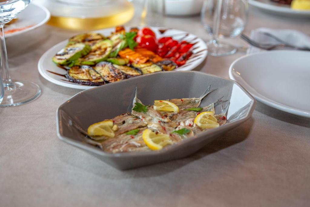 a bowl of food on a table with a plate of food at Aerial Hotel & Spa in Vlorë