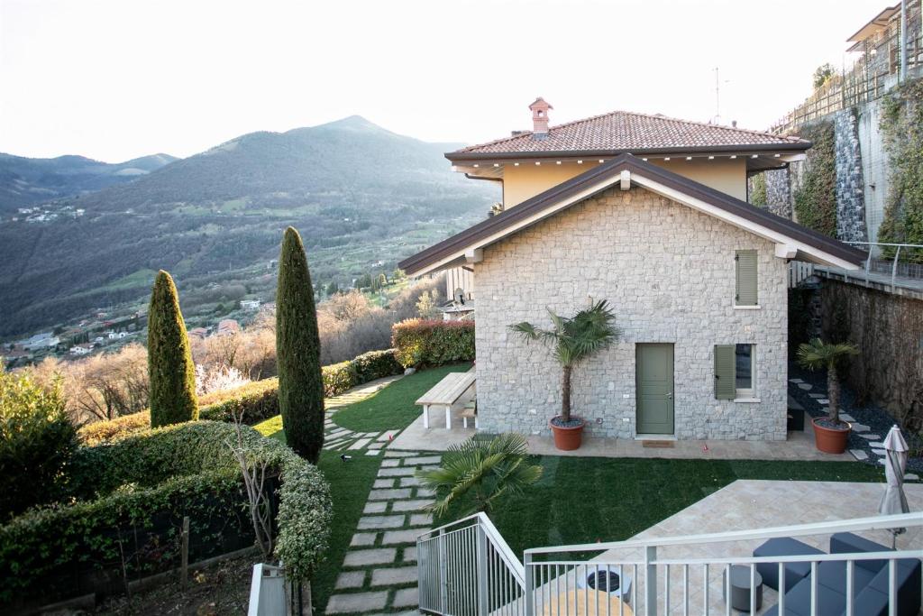 a house with a view of a yard with a fence at IseoLakeRental - Casa Amata in Riva di Solto