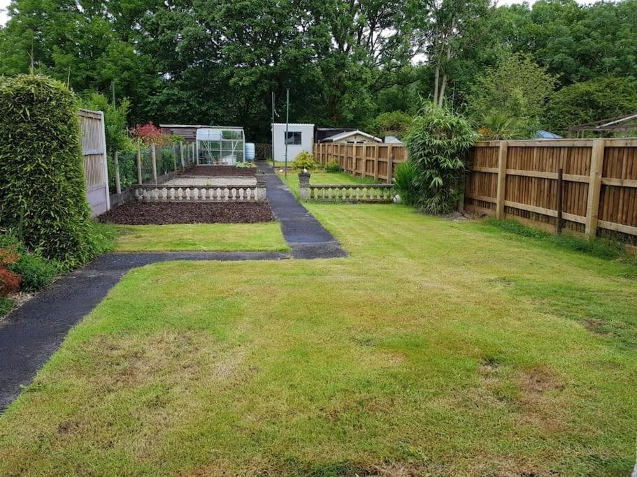 a yard with a fence and a garden at Mellte Avenue - Waterfalls House in Pont-Nedd-Fechan