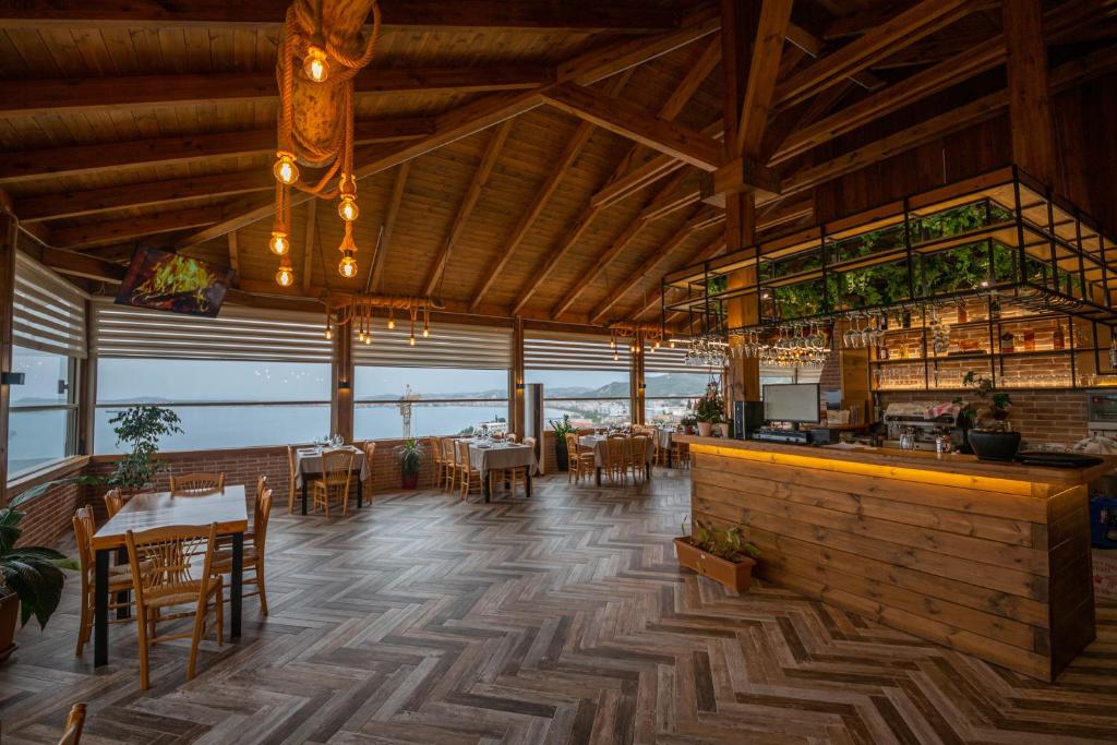 a restaurant with tables and chairs and a bar at Aerial Hotel & Spa in Vlorë