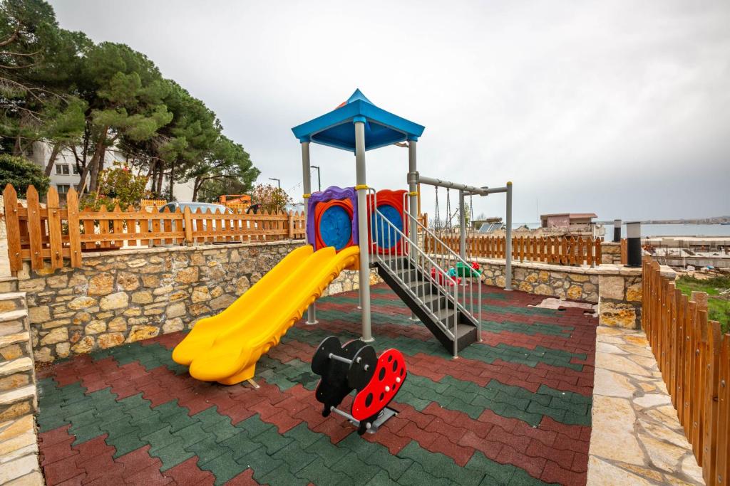 a playground with a slide and a slideintend at Aerial Hotel & Spa in Vlorë