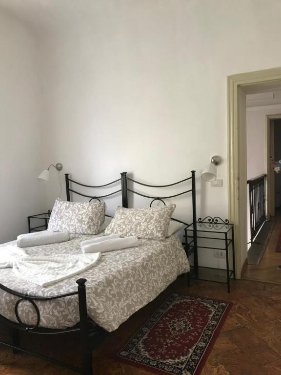 a bedroom with a bed with white sheets and pillows at Villa del Cigno in Lecco