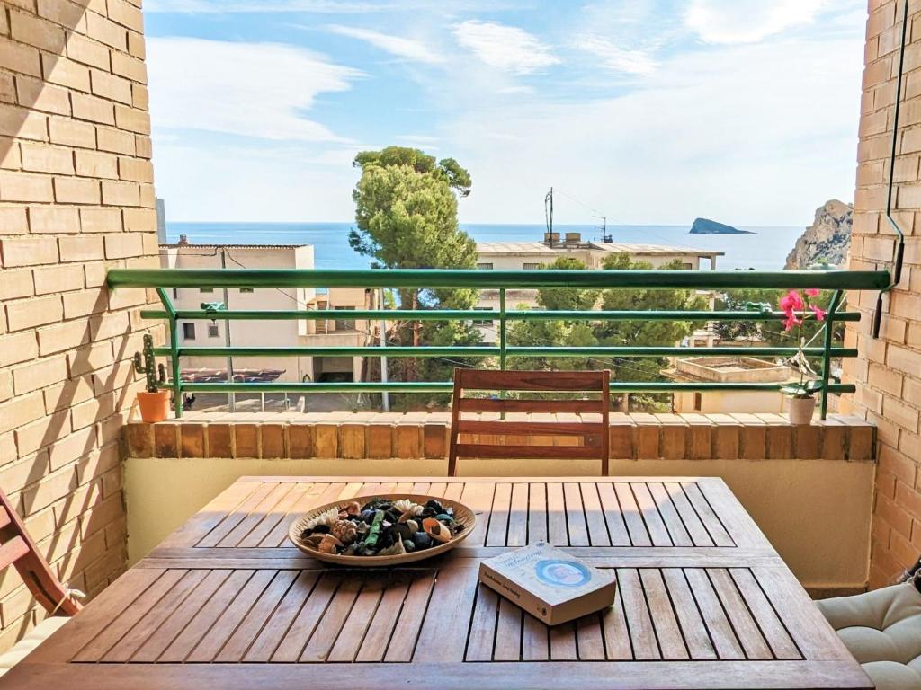 a bowl of rocks on a wooden table on a balcony at Apartment Coblanca XVI by Interhome in Cala de Finestrat