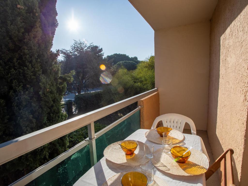 a table and chairs on a balcony with a view at Studio Côte d'Azur-5 by Interhome in La Favière