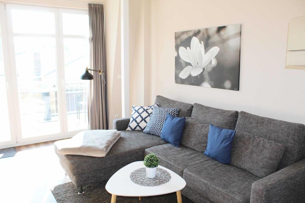 a living room with a couch and a table at Villa Marin Wohnung 23 in Zinnowitz
