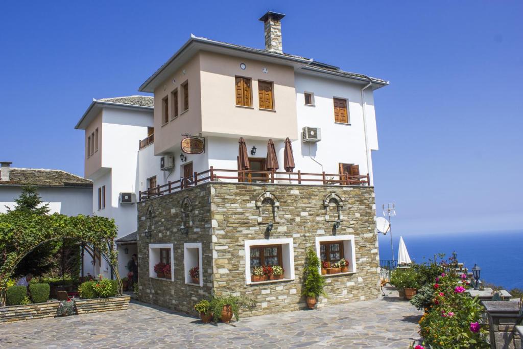 a large white building with a balcony on top at Guesthouse Papagiannopoulou in Zagora