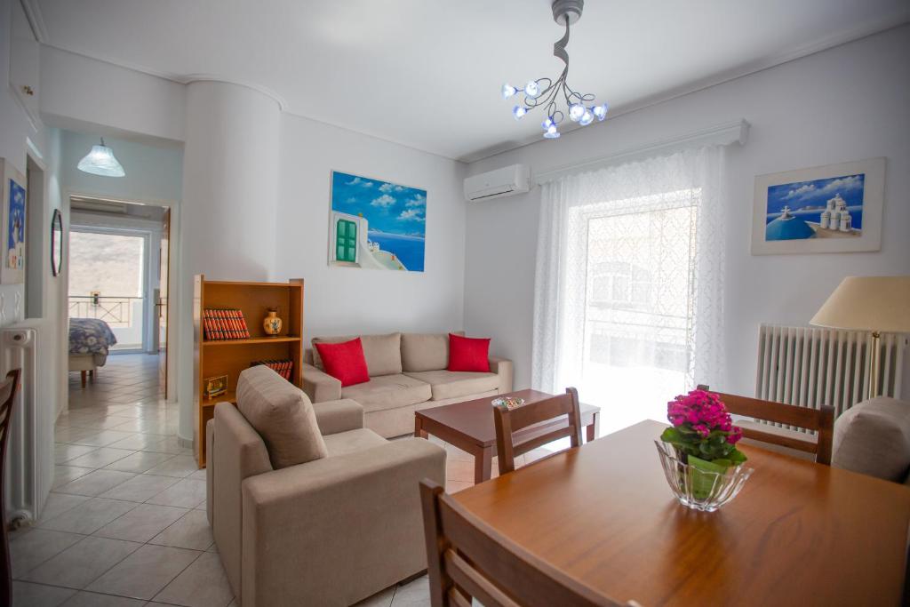a living room with a couch and a table at Poly's charming home - City center & near the beach 2bedroom apartment in Nafpaktos