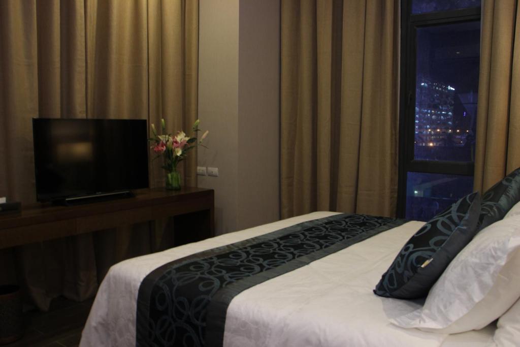 Postel nebo postele na pokoji v ubytování Golden Phoenix Hotel - Manila