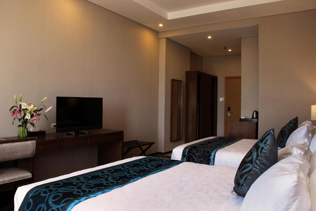 Postel nebo postele na pokoji v ubytování Golden Phoenix Hotel - Manila