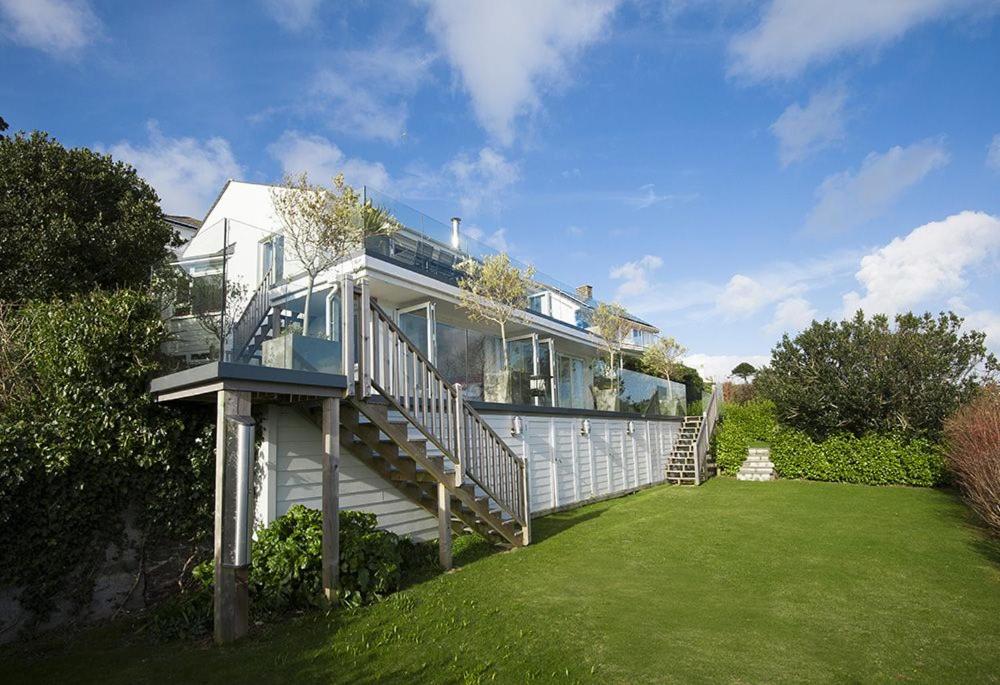 a large house with a large deck on a lawn at Dreamcatchers in Truro