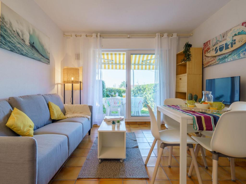a living room with a blue couch and a table at Apartment Milady Village-3 by Interhome in Biarritz