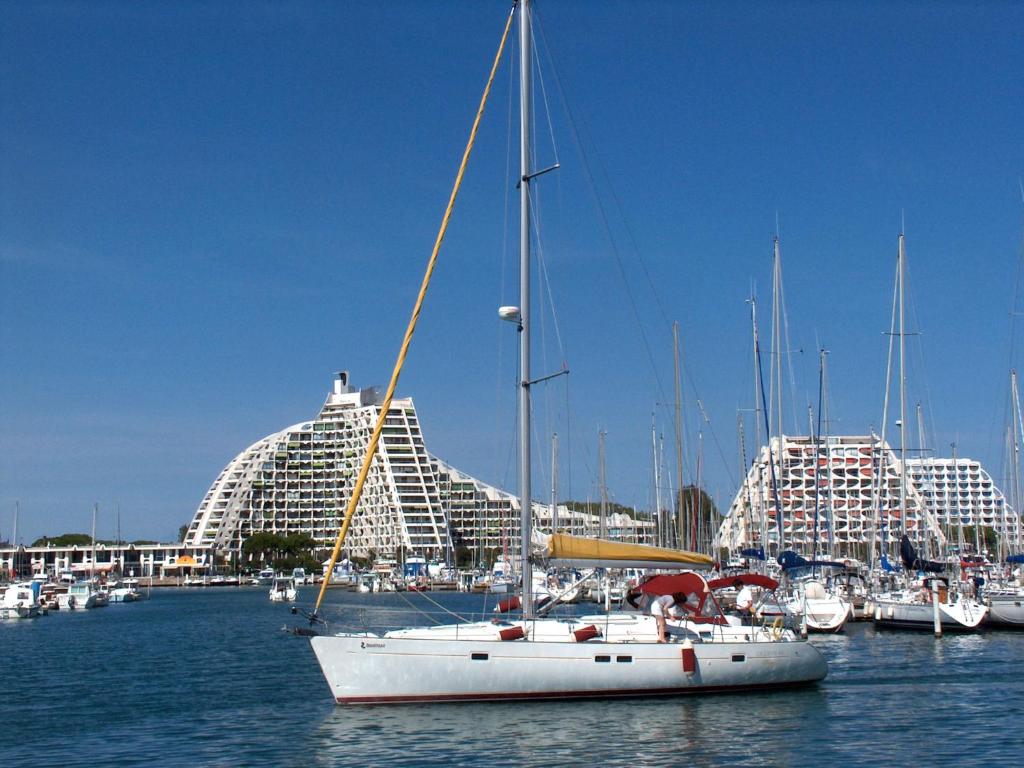 a sail boat in the water with buildings in the background at Apartment Marin&#39;Land by Interhome in La Grande Motte