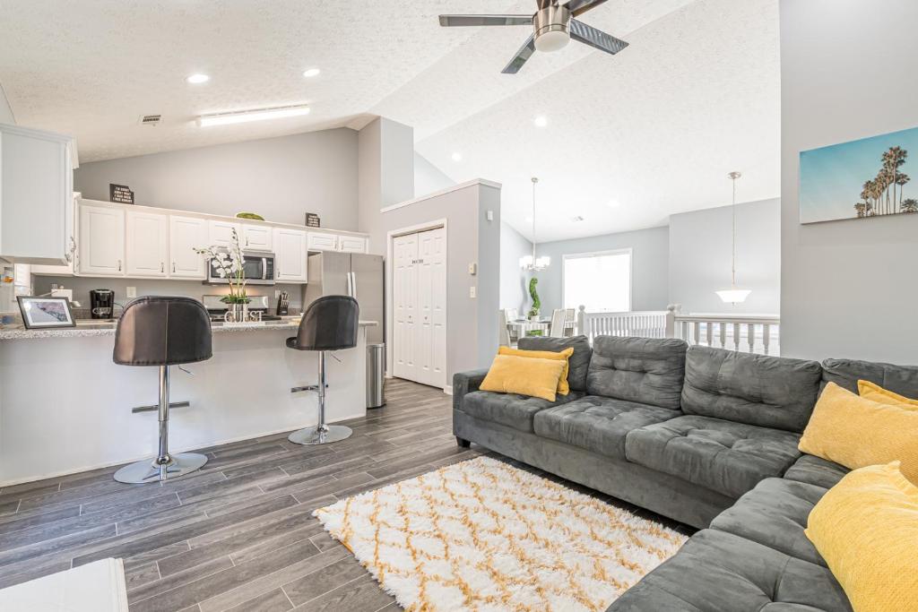 a living room with a couch and a kitchen at Unwind in a Modern Riverdale Home in Riverdale