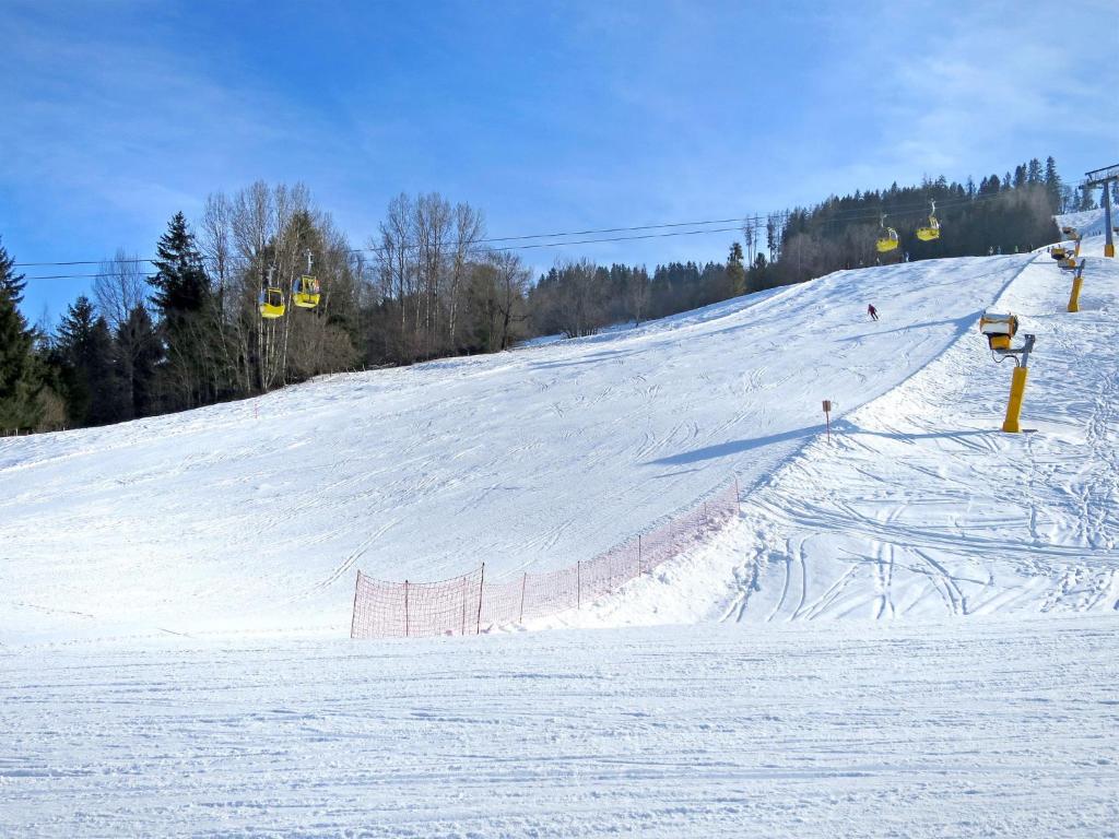 a snow covered slope with a ski lift on it at Apartment Poldi by Interhome in Haus im Ennstal