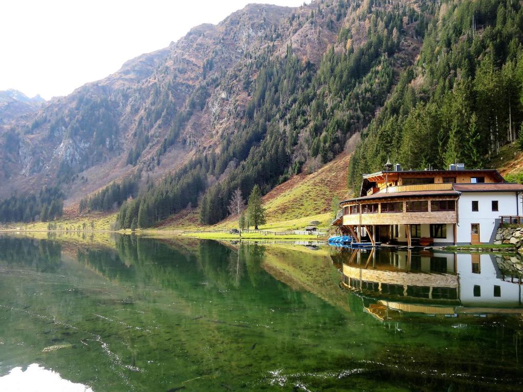 a boat on a river with mountains in the background at Apartment Poldi by Interhome in Haus im Ennstal