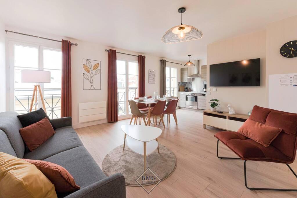 un salon avec un canapé et une table dans l'établissement Royal appartement Disneyland BMYGUEST, à Serris