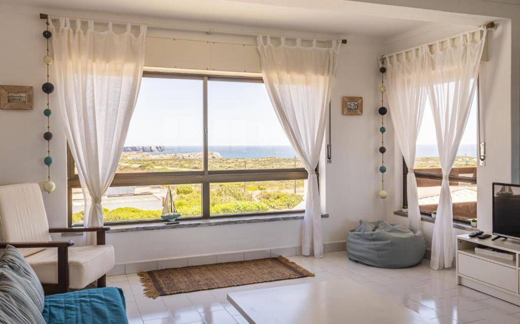 a living room with a large window with a view at Azul in Sagres