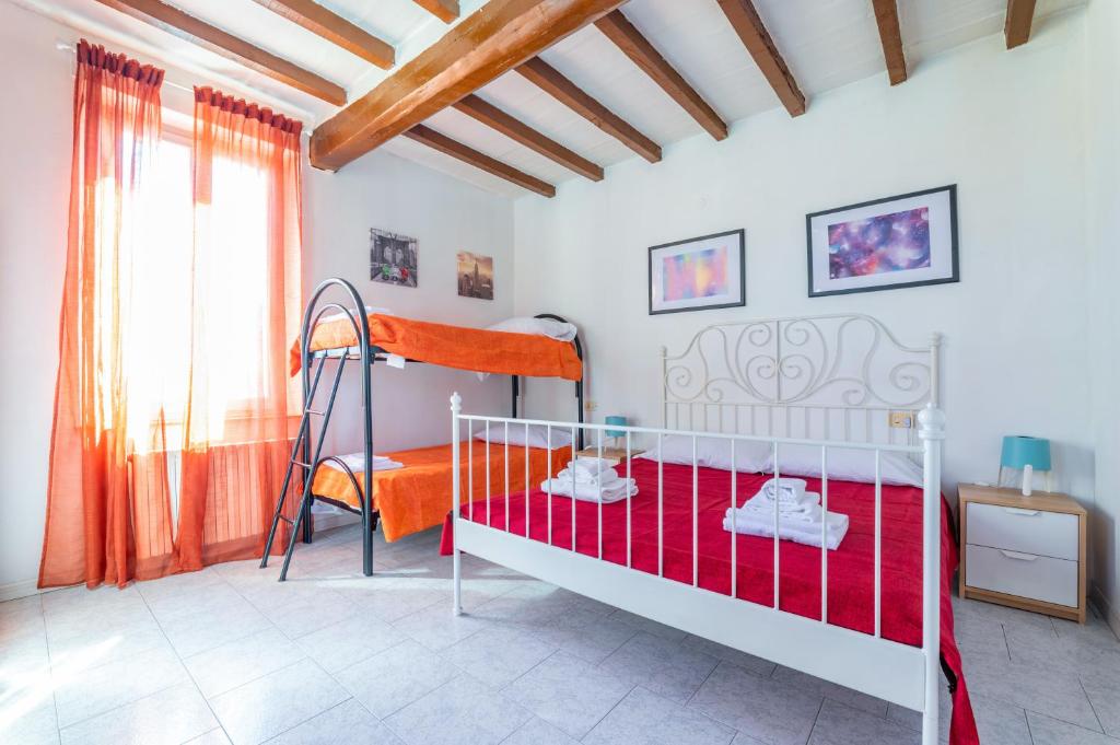 a bedroom with a bunk bed and a red blanket at Parma Centro Torri Huge Apartment x6 in Parma