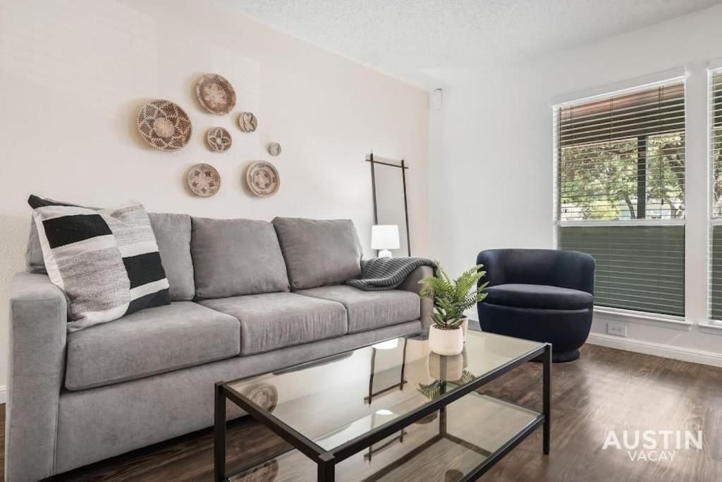 a living room with a couch and a coffee table at Walk to Everything - Fun Hyde Park Space King Bed in Austin