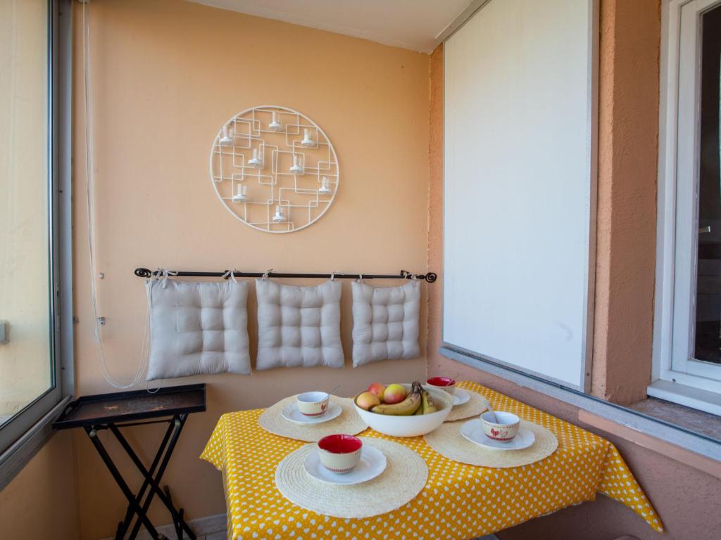 a room with a table with a bowl of fruit on it at Apartment Côte d'Azur-13 by Interhome in Bormes-les-Mimosas