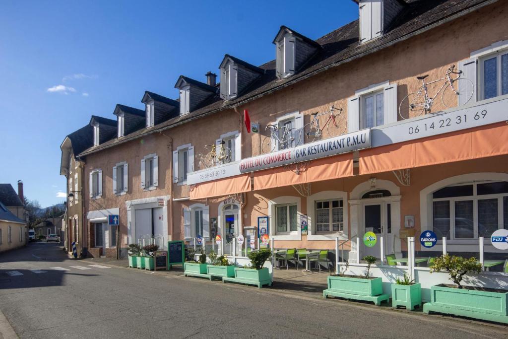 a row of buildings on a street at Hotel du Commerce in Pontacq