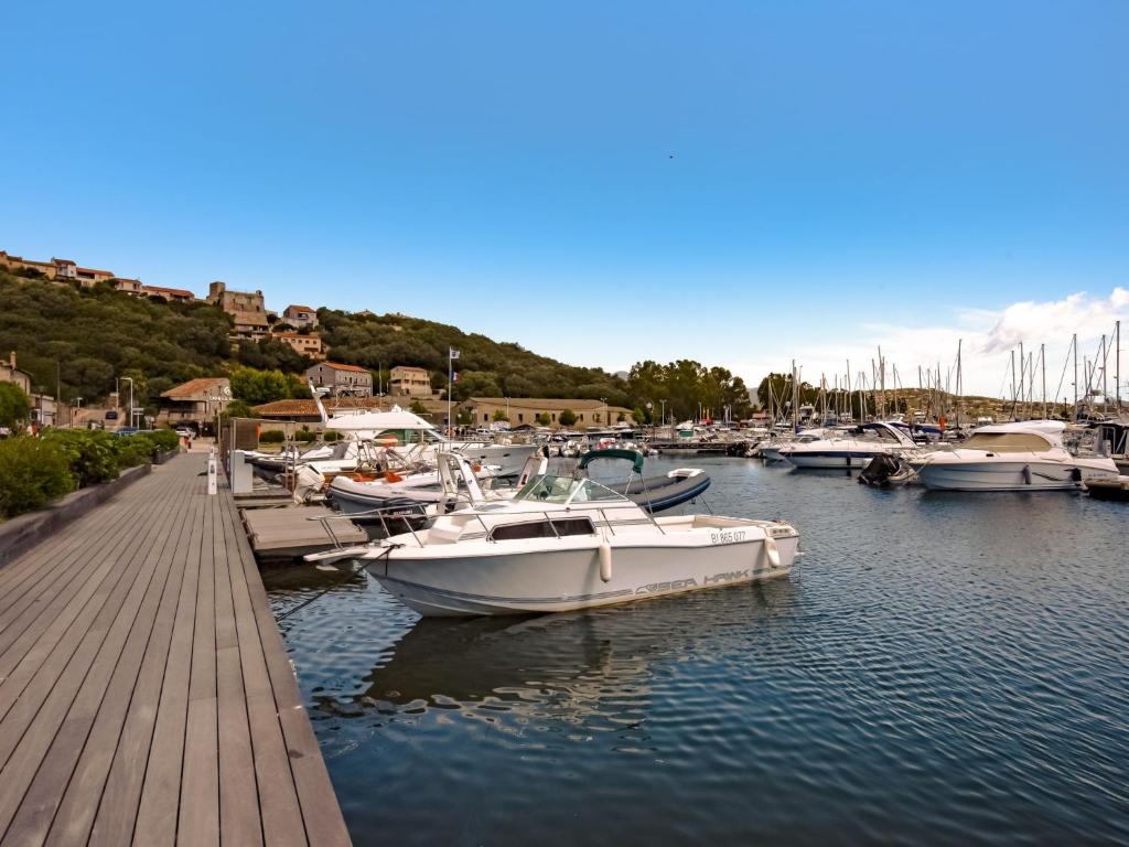 a bunch of boats are docked in a marina at Apartment Stanatura-4 by Interhome in Porto-Vecchio