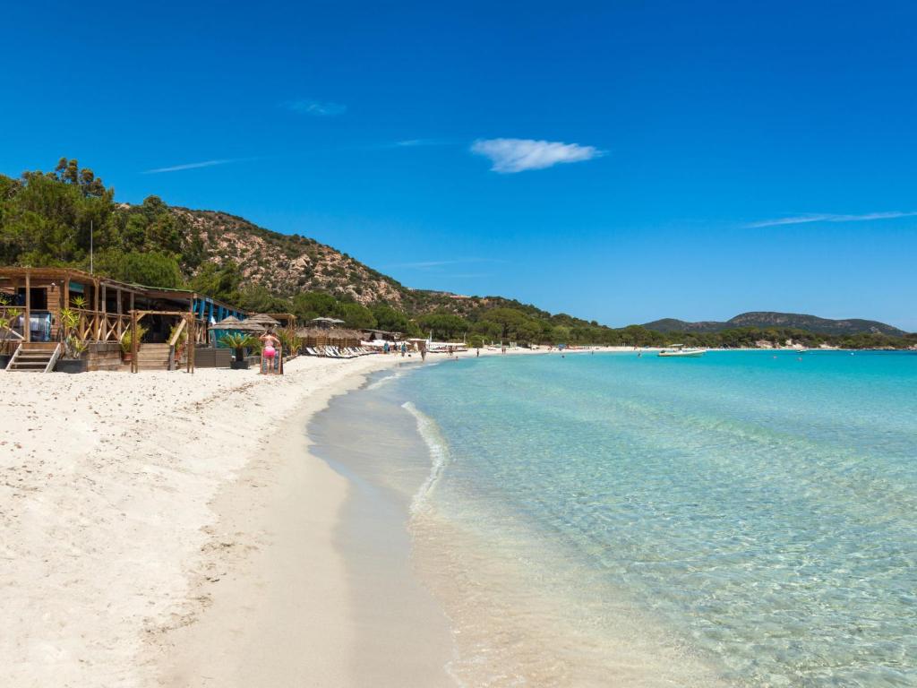 a view of a beach with people on it at Apartment Stanatura-4 by Interhome in Porto-Vecchio