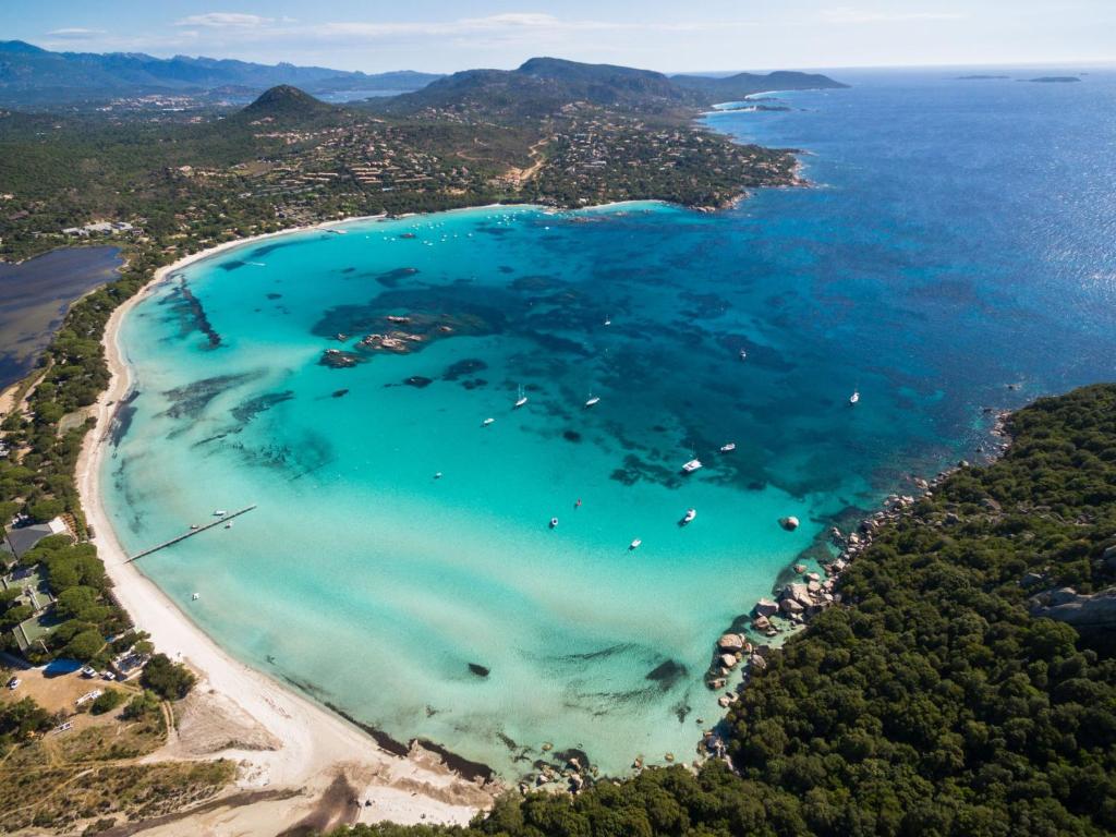 an aerial view of a beach with turquoise water at Apartment Stanatura-4 by Interhome in Porto-Vecchio
