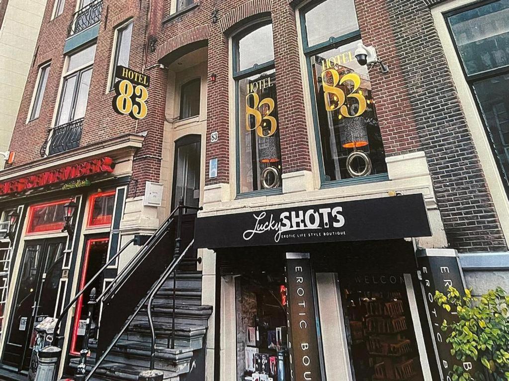 a brick building with a store on a city street at Hotel 83 in Amsterdam