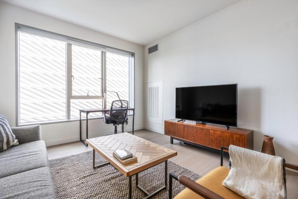 a living room with a couch and a tv at Downtown 1BR w Gym Pool nr Disney Concert Hall LAX-372 in Los Angeles