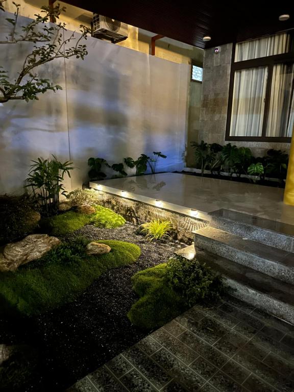 a garden with stairs and plants in a building at Lena Homestay & Villa in Dong Hoi